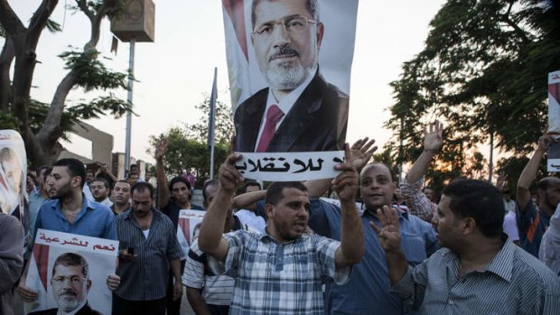 Supporters of deposed Egyptian President Mohammed Mursi gather on the Nile River corniche in the Maadi district. An Egyptian court has ordered all activities of the Muslim Brotherhood be banned, including its protests.