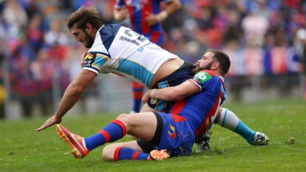 Spoiler: Titans player Dave Taylor scores a try against the Knights.