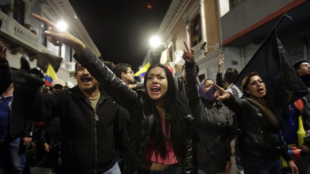 Protesters shout slogans against President Rafael Correa during an opposition march to the president's office in Quito, Ecuador, late Thursday, July 2, 2015. People turned out for protest marches across Ecuador to call for Correa's ouster just three days before a visit by Pope Francis. (AP Photo/Dolores Ochoa)