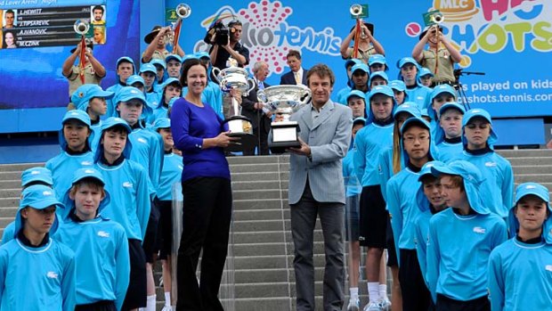 Former champions Lindsay Davenport and Matts Wilander with the mens and womens trophies for the 2013 Australian Open.