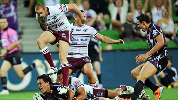Melbourne Storm's Chase Stanley dives in for a try against Manly last night.