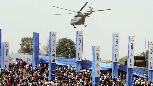 An Indian army helicopter hovers above cricket fans as part of the security at the site of the final one day international match between India and Pakistan, New Delhi, 17 April 2005.