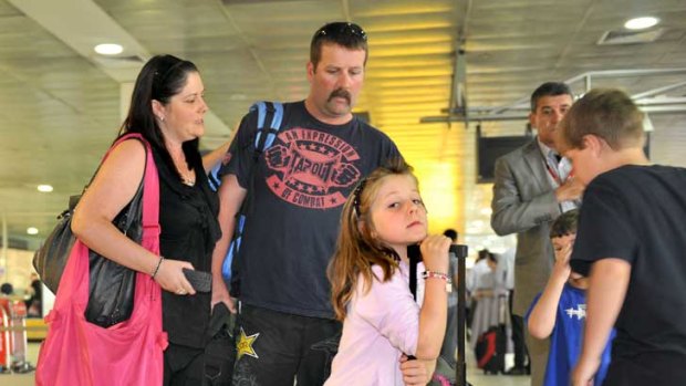 Kristy Clinton, husband Aaron and their children Emma, Matthew and Lachlan arrive at Melbourne Airport after rebooking on Qantas from Brisbane.