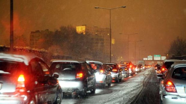 Cars are stuck in a traffic jam due to heavy snowfall  outside Lyon on Tuesday.