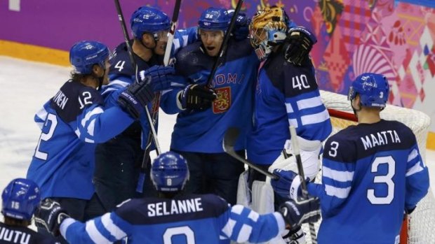 Joyful underdogs ... Finnish players celebrate after defeating Russia 3-1 in the quarter-final.