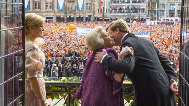 Sealed with a kiss: Beatrix embraces Willem-Alexander in front of the crowds.