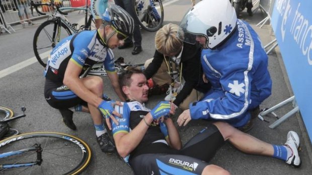 Endura team rider Tiago Machado of Portugal gets assistance after he crashed  during the 234.5 km seventh stage of the Tour de France.