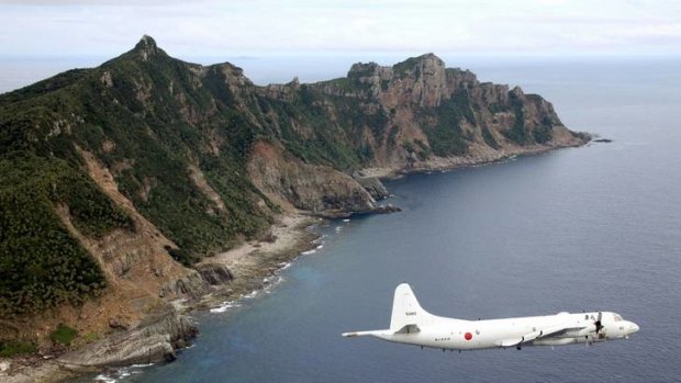 A Japan Maritime Self-Defense Force surveillance plane flies around the disputed islands in the East China Sea, known as the Senkaku isles in Japan and Diaoyu in China.