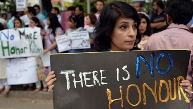 Pakistani human rights activists hold placards in Islamabad to protest against the killing of pregnant woman Farzana Parveen.