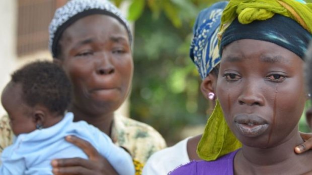A woman cries after the death of her husband, a victim of the Ebola virus in Monrovia.