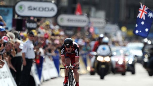 Cadel Evans powers down the finishing straight of last night's time trial to claim the yellow jersey in the Tour de France.
