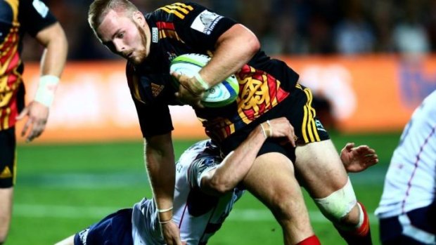 Sam Cane of the Chiefs is tackled.