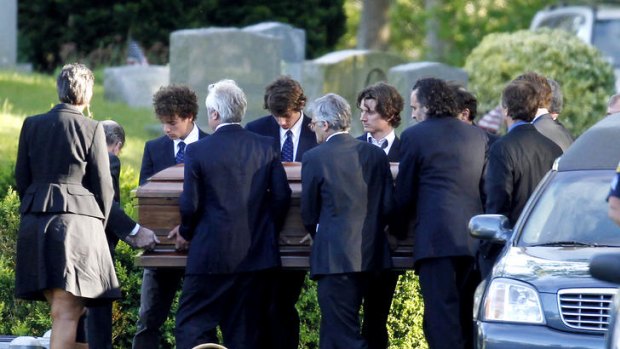 Members of the Kennedy clan, including Mary Kennedy's children, carry her coffin to her burial site.
