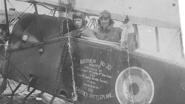 Paul McGinness with Hudson Fysh (seated right) in their warplane.