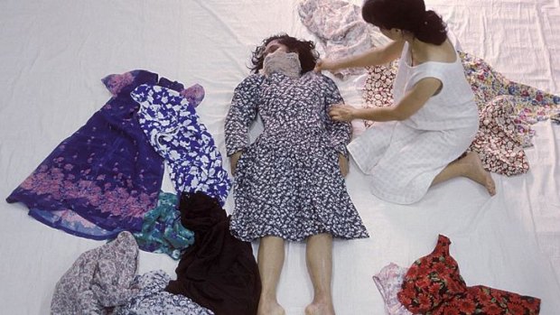 A still from Araya Rasdjarmrearnsook's video I'm Living features the artist dressing the body of an unknown dead woman.