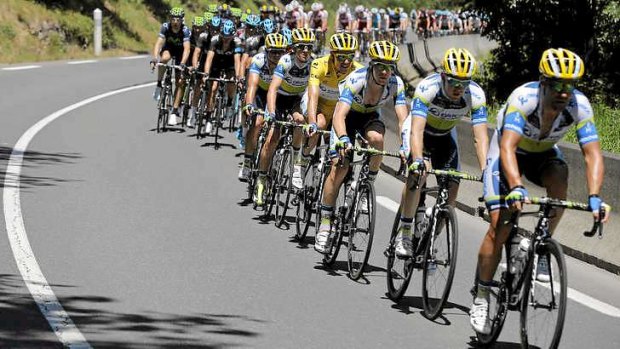 Leader in the pack: South Africa's Daryl Impey (centre) of Australia's Orica-GreenEDGE team enjoys his historic day in the leader's yellow jersey as the Tour de France climbed into the Pyrenees.