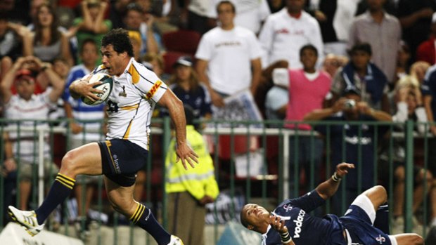 Bye ... George Smith skips by Stormer Juan de Jonghe to score the game-breaker for the Brumbies.