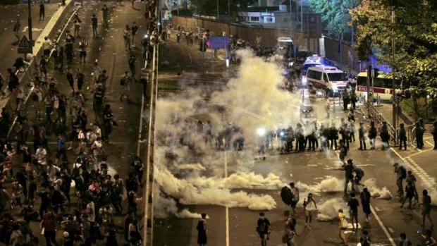 Riot police fire tear gas on student protesters occupying streets surrounding the government headquarters in Hong Kong.