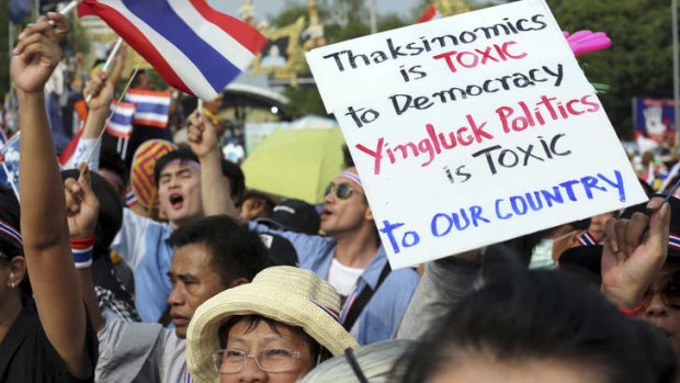 Anti-government protesters hold a banner during a demonstration against an amnesty bill in Bangkok, Thailand.
