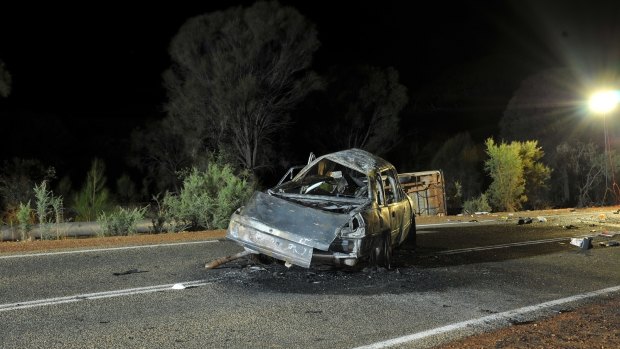 The rolled Mazda in the background flipped after colliding with this burnt out Holden Commodore