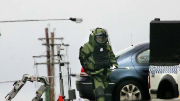 High alert ... a bomb-disposal officer after the police shootout.
