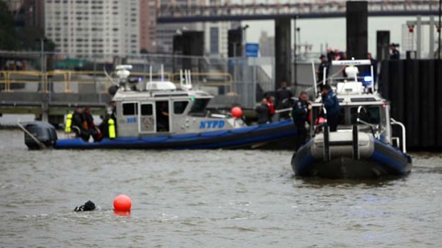 Woman missing ... rescue divers search the East River.