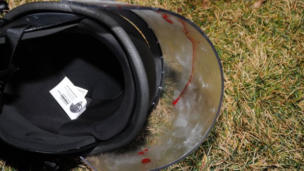 A police officer's helmet lies on the ground splashed with blood in Ferguson. He was one of two officers shot on Thursday morning in the troubled Missouri city.