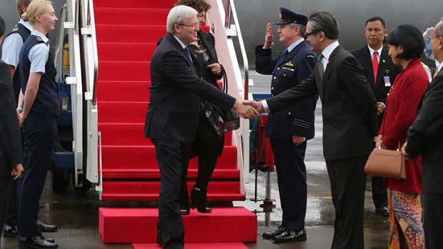 Prime Minister Kevin Rudd, pictured being greeted by Indonesian Foreign Minister Marty Natalegawa, has also asked young Indonesian to follow him on Twitter.