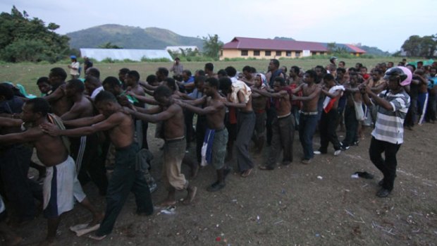 Prisoners are led away from the Third Papuan People's Congress. At least six people were killed and about 300 arrested by Indonesian police and military.