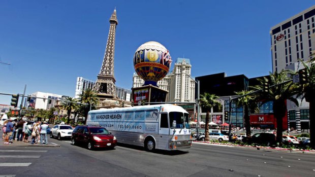The Hangover Heaven bus cruises down the Las Vegas Strip. The service offers to "cure" morning-after revellers of their hangovers.