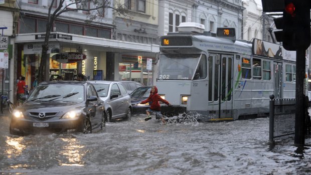 Tram ahoy ... flooding yesterday on the corner of Chapel Street and Commercial Road in Prahran, Melbourne.