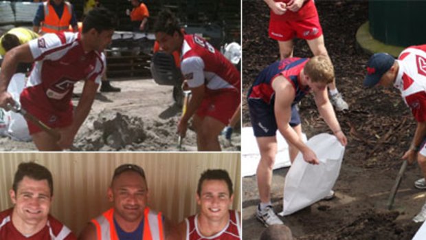 Super Rugby players from the Queensland Reds helped fill sand bags for the many affected areas.
