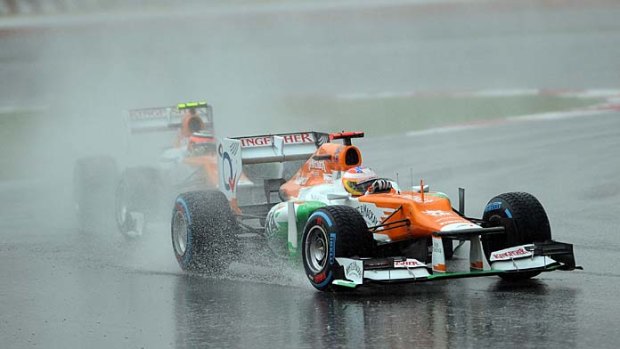 Force India-Mercedes driver Paul di Resta of Britain drives in the wet during the Malaysian Grand Prix.