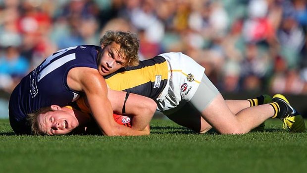 Tiger tackled: Docker Paul Duffield has Jack Riewoldt under wraps.
