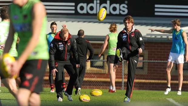 Kicking on: Essendon coach James Hird during a closed training session at Windy Hill on Thursday.