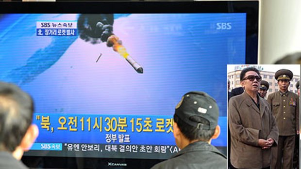 Blasted . . . South Koreans watch a  news broadcast about North Korea's missile launch yesterday. World leaders condemned the move as provocative. Inset:  The North Korean leader, Kim Jong-il.