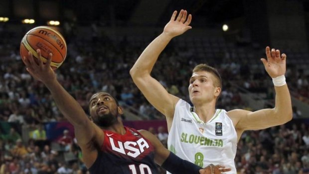 Kyrie Irving of the US drives to the basket past Slovenia's Edo Muric.