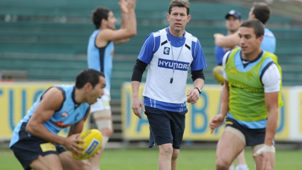 Carlton coach Brett Ratten keeps an eye on Eddie Betts and Andrew Carrazzo during training.