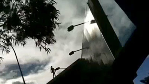 A naked man was filmed standing on the Wellington Street billboard, opposite Perth's train station, by two university students, who posted the mobile phone footage on YouTube.
