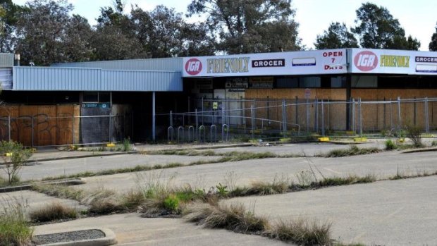 Fences have gone up around the site of the suburb's former bustling local centre, which began a slow decline years before the remaining supermarket closed in 2004.