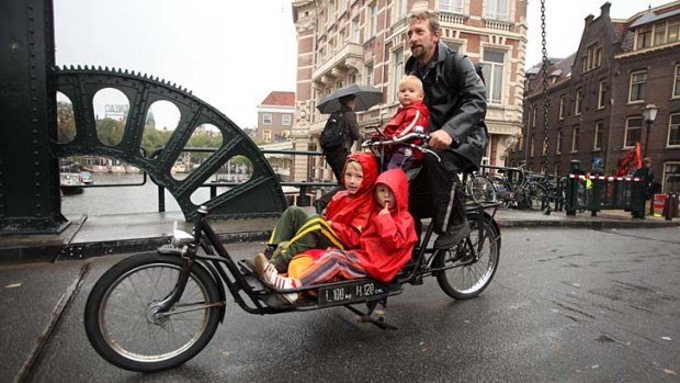 The Netherlands: Dutch children are the happiest in the world. Reyer Meeter is taking his kids on the daily school run, by bicycle.