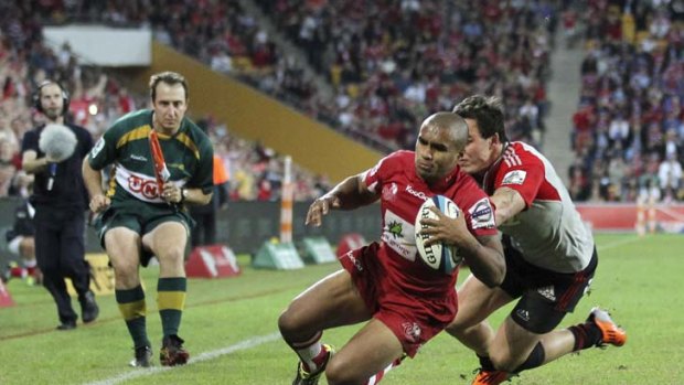 Leadrship skills ... Reds halfback Will Genia shrugs off the Crusaders Zac Guildford to score yesterday.