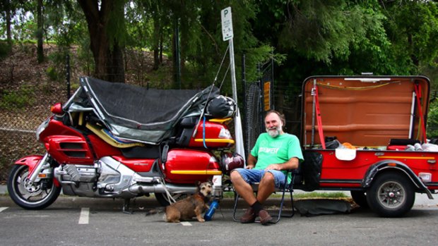 Electrician Ian Pettett and his dog Oscar live in his Honda Goldwing Motorbike and trailer at Brisbane parks.