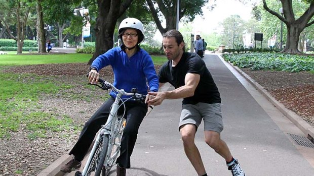 Something she'll never forget&#8230; cycling coach George Mihelakis teaches Sian Lian Lee, 56, how to ride a bike as part of National Ride to Work Day.