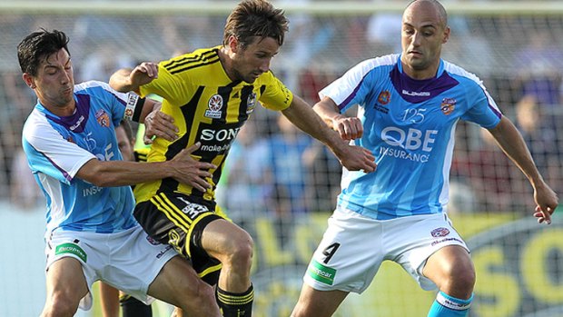 Jacob Burns (L) and Billy Mehmet have re-signed with Perth Glory. Pictured here contesting with Nicholas Ward (C) of Wellington.