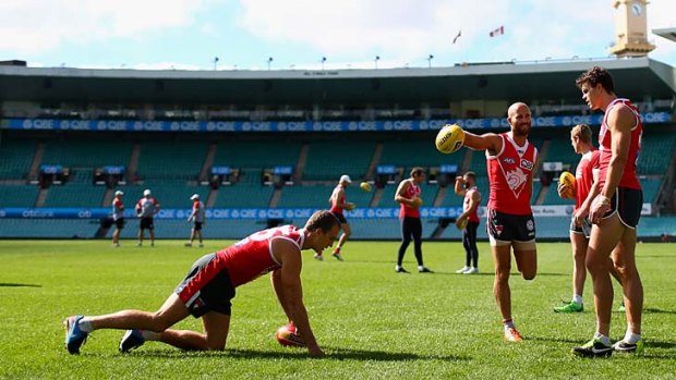 Ted Richards, Jarrad McVeigh and Mike Pyke warm up during a training session at the SCG last week.