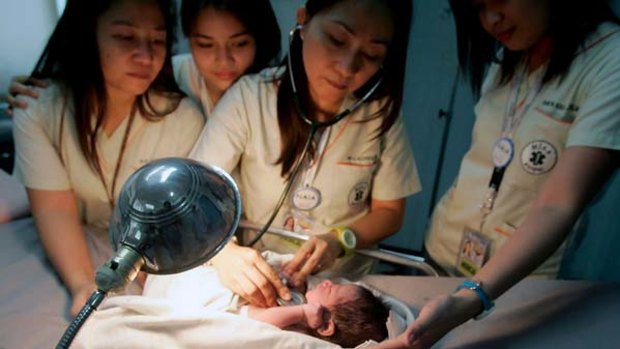 Doctors at Ninoy Aquino International Airport attend to a newly born boy found by aircraft cleaners in a bin on a Gulf Air flight.
