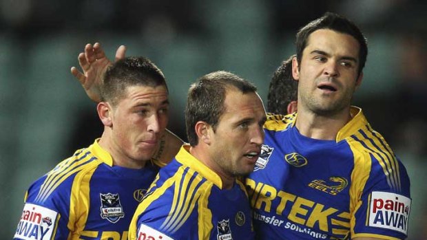 Eels utility Tom Humble, far left, being congratulated for a try last year.