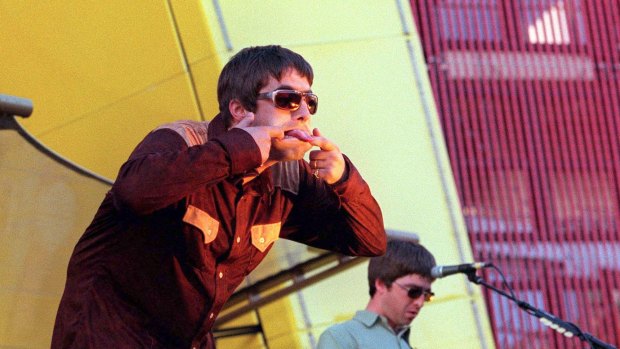 Liam Gallagher (at left) and brother Noel on stage with Oasis in 1997.
