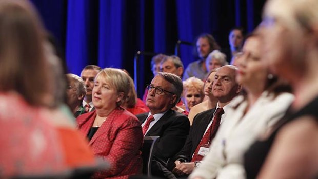 Former treasurer Wayne Swan listens to Prime Minister Kevin Rudd at the ALP campaign launch in Brisbane on Sunday.